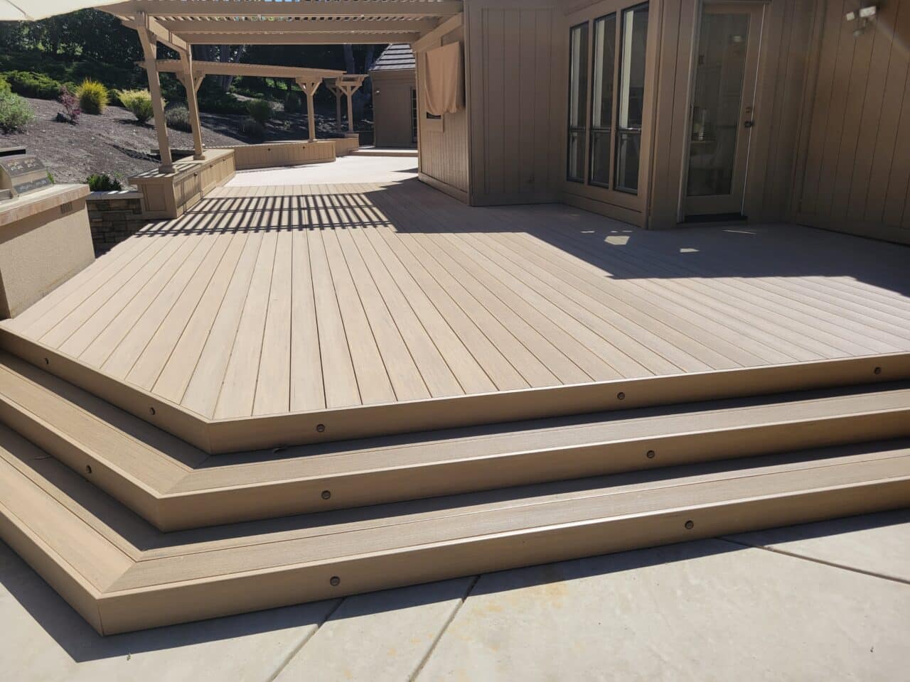 wide composite deck steps with unobtrusive outdoor lighting