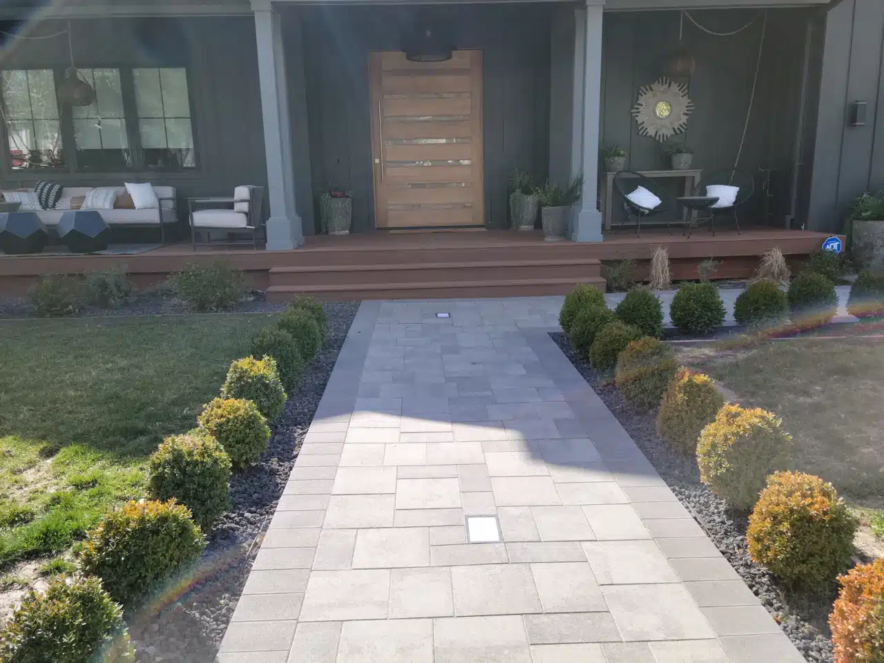 Photo of a front porch with an attractive entryway include a paver pathway to the porch